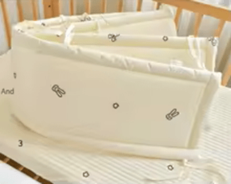 pare-chocs-bébé-sur-lit